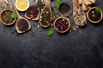 Various dried tea in wooden spoons