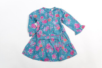 Elegant light children summer dresse. Blue dress with flowers, isolated