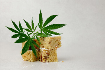 Homemade pie and powdered sugar with CBD oil. Cannabis kitchen. Marijuana cake on white textured...