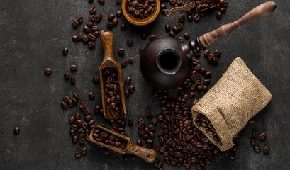 Foto op Canvas Turkish coffee with roasted beans top view flatlay. Stone background with grains, cezve pot, sack and spatula © primopiano