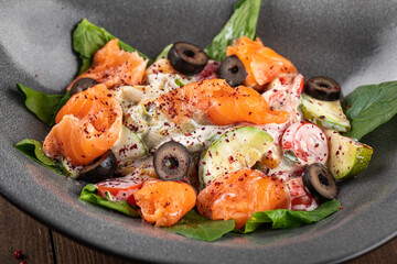 Closeup on gourmet salmon salad with vegetables