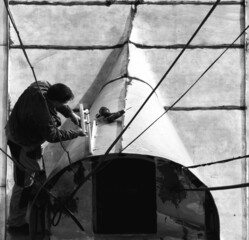 man mounts wi-fi on old roof