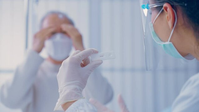 Asian senior male consult with doctor after know the result from ATK.
