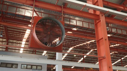 Big industrial cooler red fans in factory for reduced heat in operation ventilation of plant,...