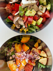 sweet and savory salads with fresh ingredients in a stainless steel bowl