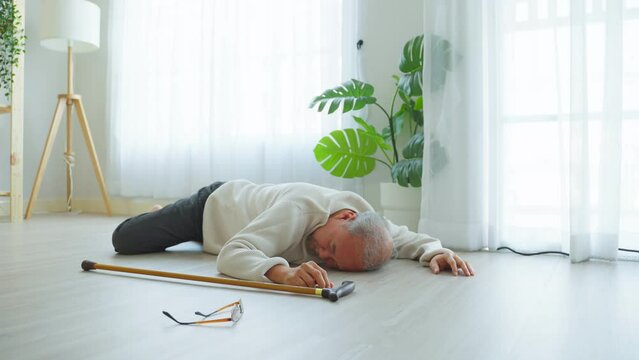 Asian senior male falling on the ground while walk with walker at home