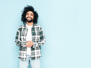 Handsome smiling hipster  model.Sexy unshaven Arabian man dressed in summer shirt and jeans...