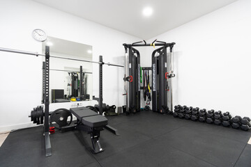 Exercise equipment and dumbbells in empty gym