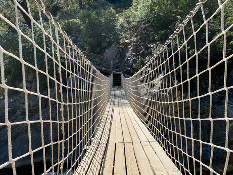 Wooden Bridge In Canyon With Net