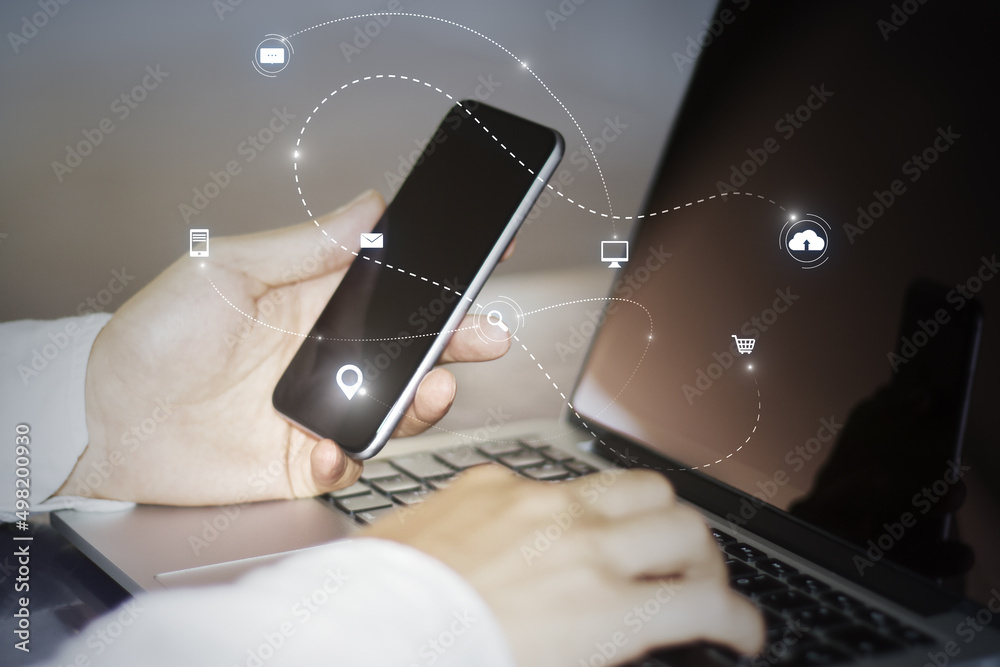 Poster Close up of hand using laptop keyboard and phone with abstract SEO search and communication hologram on blurry background. Double exposure.