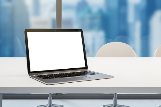 Close up of empty white laptop screen with mock up place on desktop and window with blurry blue city background, Meeting and equipment concept. 3D Rendering.