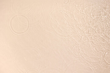 Transparent beige clear water surface texture with ripples, splashes. Abstract nature background...