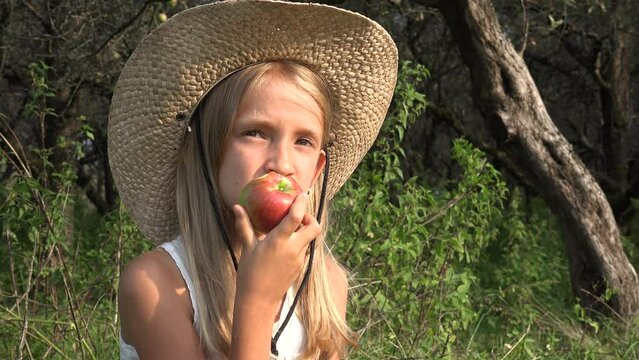 Child Eating Apple, Girl in Orchard, Kid Tasting Fruits in Tree, Farmer Blonde Girl at Village at Countryside