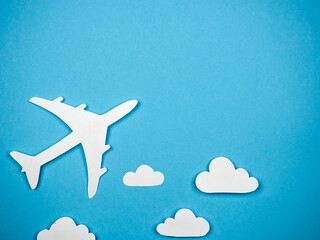 Airliner on a blue background in the clouds. The concept of travel, rest and flight.
