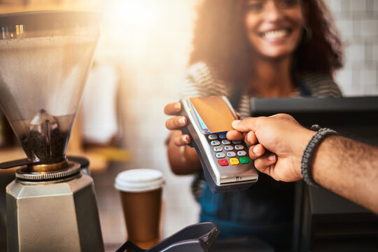 The smart, effortless and easy way to pay. Closeup shot of a customer making a credit card payment in a cafe.