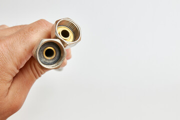 Water hose with threaded nuts. Plumbing work.