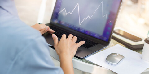 Cropped image of hands young asian woman working on her laptop computer on desk at outdoor cafe, Investor trading stock and analysis investment