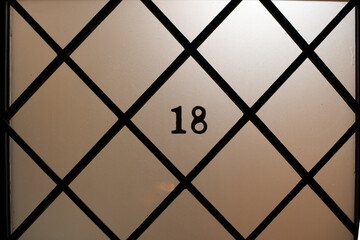 Lattice window pane with the number 18 or chai in Hebrew, which according to Jewish tradition, is a...