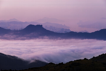Idyllic landscape of silhouette of natural landmark Lion Rock in Hong Kong city at dawn