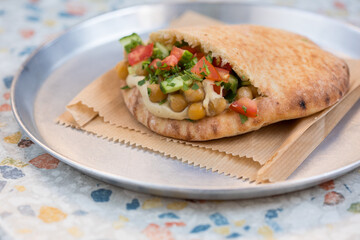 Falafel filled with humus, salads and sauces 