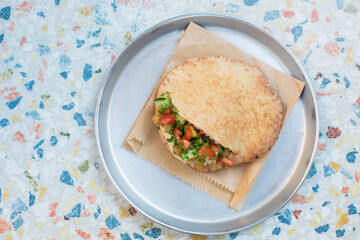 Falafel filled with humus, salads and sauces 