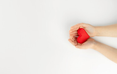 Red heart in hands on white background