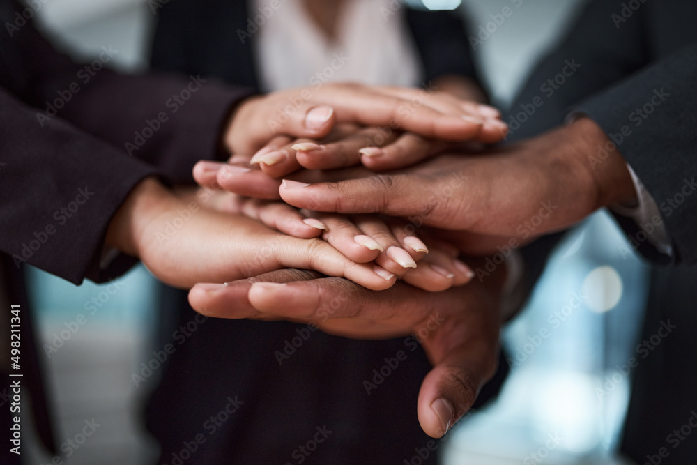 Poster trust is our foundation. cropped shot of a group of unrecognizable businesspeople joining their hand