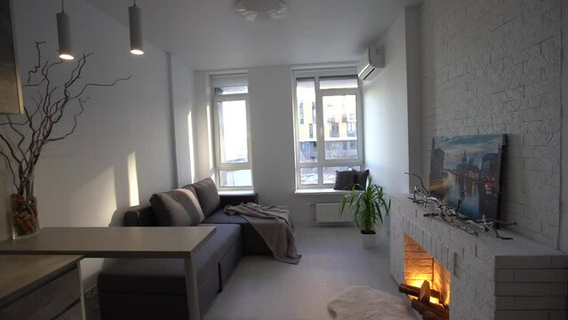 Modern minimalistic dark gray loft style studio apartment interior design. kitchen, sitting area, workplace