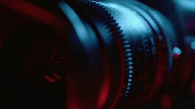 Cine lens focusing close up. Macro shot of professional camcorder with focus and aperture ring. Concept of cinema or movie shooting and video production