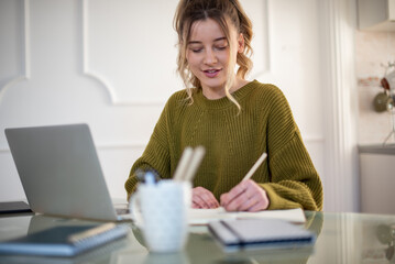 Woman working from a home on her a laptop