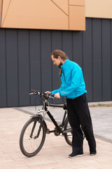 Man in a blue jacket with a bicycle