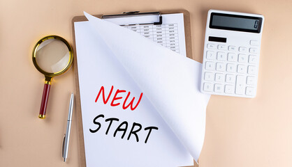 Clipboard with chart and text NEW START with magnifier ,calculator on beige background