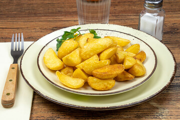 baked potato in a plate on a wooden table