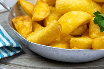 close up of baked potato in dish