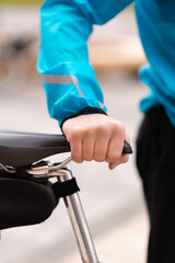 Man holding his bicycle seat. Cropped Image