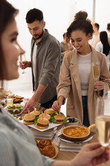 Group of people enjoying brunch buffet together indoors