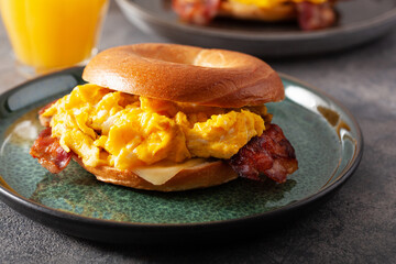 breakfast egg and bacon sandwich on bagel with cheese