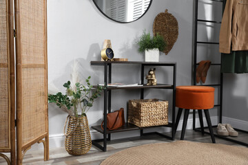 Stylish room interior with console table and beautiful decor elements