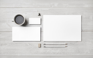 Blank corporate stationery set on light wooden background. Template for branding identity. Flat lay.