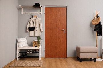 Modern hallway interior with shoe rack and wooden coat stand