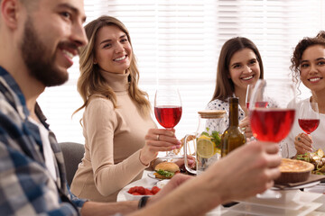 Group of people having brunch together at table indoors