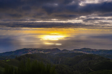 Sunset over Atlantic Ocean with coastal villages in Madeira, Portugal