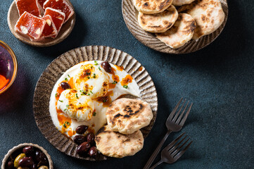 Cilbir or Turkish Eggs. mezze: poached eggs topped over herbed greek yogurt, then drizzled with hot spiced paprika olive oil. Traditional Turkish breakfast with rahat