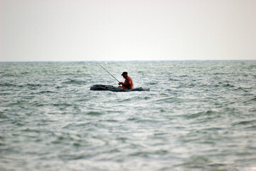 Fototapeta na wymiar fisherman catches fish in the Black sea on a boat 