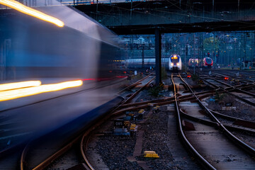 Blue hour at the main station of Hagen Germany with many lights, signals, catenary, glistening...