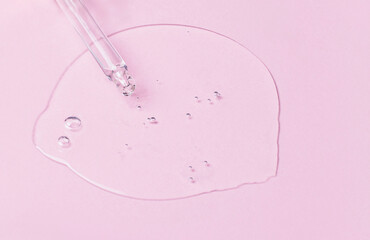 Cosmetic oil, serum or serum and pipette on a pink background. Medicine, beauty and health concept