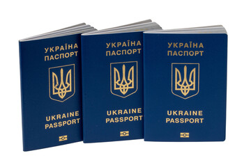 Three passports of Ukrainian citizens or migrants for visa-free travel to the European Union isolated on a white background. Clipping path. Refugees in the Ukraine conflict with Russia.
