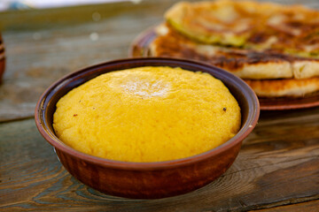 polenta is a dish made from corn flour, served with a book and cheese. Traditional food in Romania and the Republic of Moldova