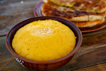 polenta is a dish made from corn flour, served with a book and cheese. Traditional food in Romania and the Republic of Moldova