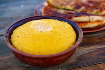 polenta is a dish made from corn flour, served with a book and cheese. Traditional food in Romania...